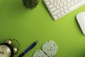 Top view of blank paper page on green background office desk and different objects. Minimal flat lay style Royalty Free Stock Photo