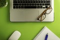 Top view of blank paper page on green background office desk and different objects. Royalty Free Stock Photo