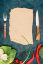 Top view of blank parchment, fork with knife and raw vegetables Royalty Free Stock Photo