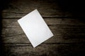 Top view of a blank sheet of white paper lying on a wooden rustic desk Royalty Free Stock Photo