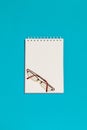 Top view of blank spiral notebook and glasses Royalty Free Stock Photo