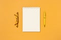 Top view of blank spiral notebook, pen and glasses Royalty Free Stock Photo