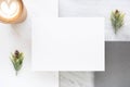 Top view of blank white card overlap on grey card with hot coffee cup and pine leaf on two layer step of marble table top.Mock up Royalty Free Stock Photo