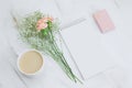 blank white notebook,coffee cup,gift box and boquet of carnation and gypsophila flowers on a marble background Royalty Free Stock Photo