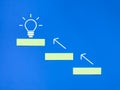 Top view block set up as staircase with arrows and light bulbs icon on the top. Royalty Free Stock Photo