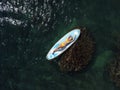 Top view on blonde woman in yellow bikini relaxing on the sup board. Young attractive woman in the sea on the Stand Up Royalty Free Stock Photo