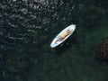 Top view on blonde woman in yellow bikini relaxing on the sup board. Young attractive woman in the sea on the Stand Up Royalty Free Stock Photo