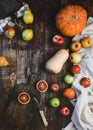 top view of blood oranges, pears, apples, pumpkins, wooden board and knife on rustic