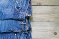 Top view of blue denim jeans arranged on wooden background. Beauty and fashion clothing concept Royalty Free Stock Photo