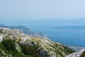 Top view on blue fogged sea bay from the mountain cliffs of Biokovo national park near Makarska resort.