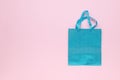 Top view of a blue gift bag on a pink background Royalty Free Stock Photo