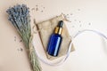 top view of blue glass dropper bottle vith lavender aromatic essential oil or extract on beige background. Bunch of scented dry Royalty Free Stock Photo