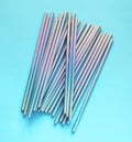 Top view of blue glisten paper disposable eco-friendly straws. Drinking straws for party on blue background Royalty Free Stock Photo