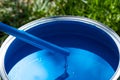 Top view of blue paint can, can lid, new brush on green grass Royalty Free Stock Photo