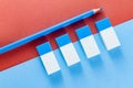 Top view of blue pencil and erasers on color papers Royalty Free Stock Photo