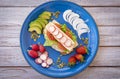 Top view of a blue plate with an healthy and dietetic sandwich with turkey meat and vegetables - healthy and tasteful eating -