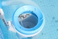 Top view of the blue skimmer for cleaning the pool in clear water. Contaminated pool cleaning concept Royalty Free Stock Photo