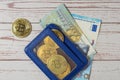 Top view of a blue wallet with Bitcoin coins, Euro bills and a bank card on a wooden background. Close-up Royalty Free Stock Photo