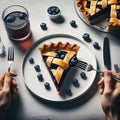 Woman\'s hands holding fork and knife over blueberry pie on white table, top view Royalty Free Stock Photo