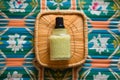 top view of body lotion in a green jar on a rattan mat