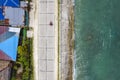 Top view of the Bohol circumferential highway hugging the coastline near the border of Valencia and Garcia Hernandez Royalty Free Stock Photo