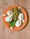 Top view. Boiled eggs with mayonnaise with peas and green onions