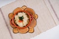 Top view of boiled rice with greens and tomato in a bowl on round woodcuts on a tablecloth Royalty Free Stock Photo