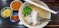 Top view of boiled rice with sliced white snapper and celery or vegetable in soup on bowl. Royalty Free Stock Photo