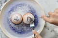 Top view of Bombolone is an Italian filled doughnut and is eaten as a snack food and dessert with hands cutting Royalty Free Stock Photo