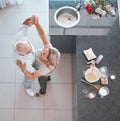 Top view, bonding couple or dancing in kitchen of house or home and baking ingredients on countertop for breakfast food Royalty Free Stock Photo