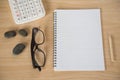 Top view book , calculator, glasses on wooden table . Royalty Free Stock Photo