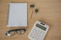 Top view book , calculator, glasses on wooden table . Royalty Free Stock Photo