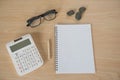 Top view book , calculator, glasses on wooden table . Royalty Free Stock Photo