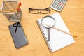 Top view book , calculator, glasses on wooden table Royalty Free Stock Photo