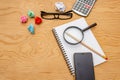 Top view book , calculator, glasses on wooden table Royalty Free Stock Photo