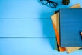 top view book mockup and pencil note on blue wood table