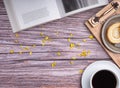 Top view of a book with roll cake on a plate on a wooden tray and a white coffee cup on a wooden table. Royalty Free Stock Photo