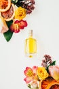 top view of bottle of aromatic perfume with beautiful flowers and grapefruit slices