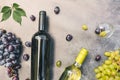 Top view of bottle red and white wine, green vine, wineglass and ripe grape on vintage dark stone table background. Wine Royalty Free Stock Photo