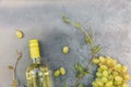 Top view of bottle white wine, green vine and ripe grape on vintage gray stone table background. Wine shop wine bar Royalty Free Stock Photo