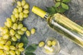 Top view of bottle white wine, green vine, wineglass and ripe grape on vintage gray stone table background. Wine shop Royalty Free Stock Photo