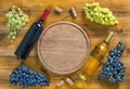 Top view of  bottle of wine,  bunch of grapes and  round cutting board Royalty Free Stock Photo