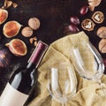 top view of bottle of wine empty glasses hazelnuts and figs Royalty Free Stock Photo