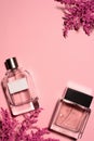 top view of bottles of perfumes with pink branches Royalty Free Stock Photo