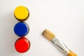 Top view of bottles of primary color on white background