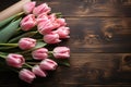 Top view Bouquet of pink tulips and blank paper on wood