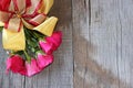 Top view of bouquet of red roses with ribbon on old wooden board background. Right space for message. romance love card or wedding Royalty Free Stock Photo