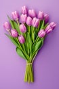 Top view bouquet of tulip flowers on violet with copy space background.