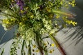 Top view of a bouquet of wild herbs and flowers that stands on a light table Royalty Free Stock Photo