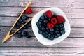 Top view of a bowl of blueberries on the table with a kitchen tool